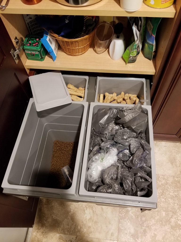 Base cabinet double pull-out bins pulled open