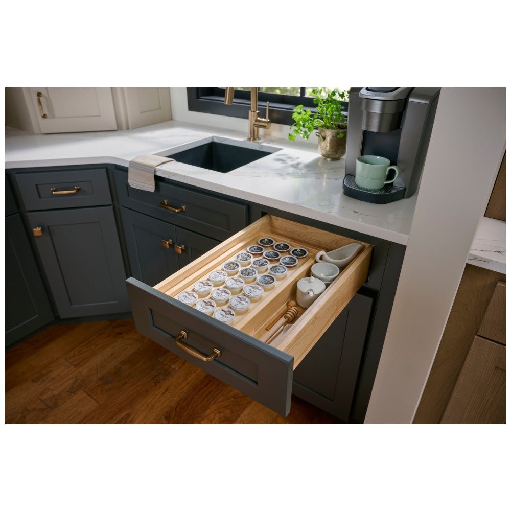 Coffee pod drawer organizer in an open kitchen drawer below the coffee maker