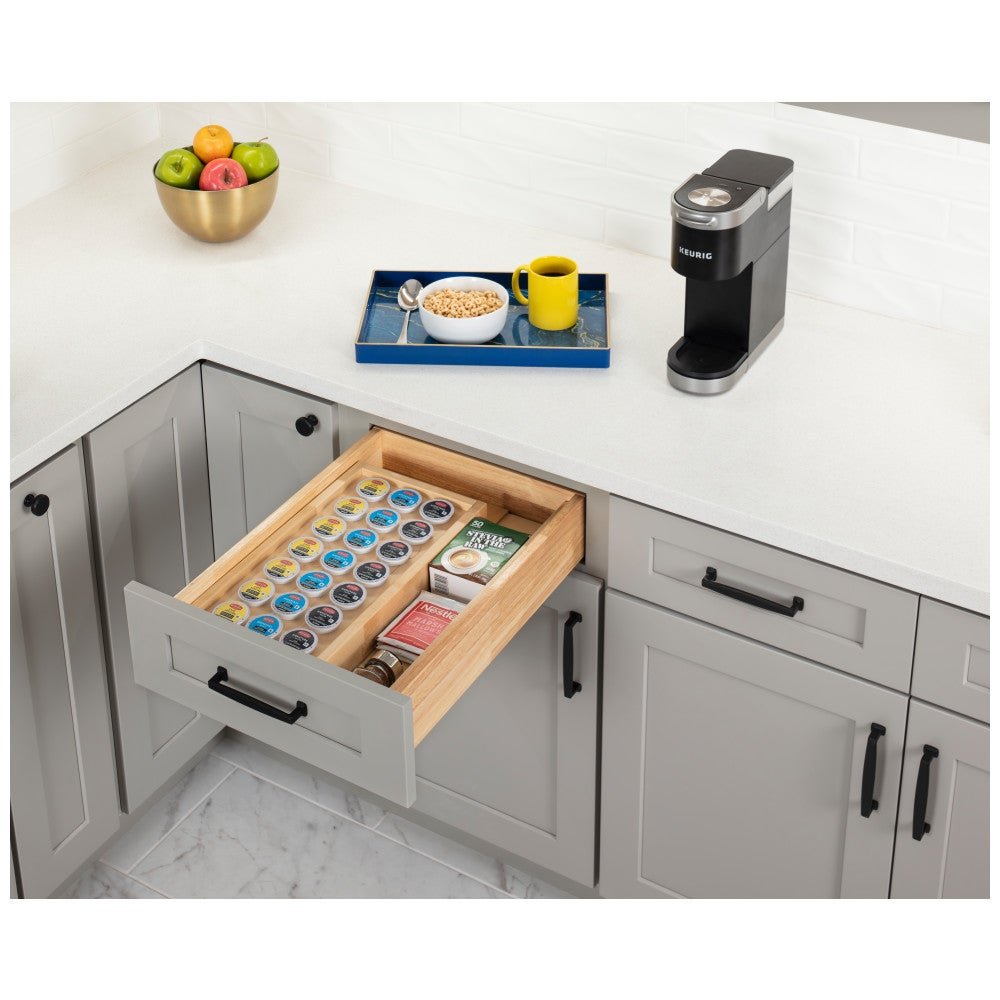 Coffee pod drawer insert filled with pods in a corner base cabinet drawer