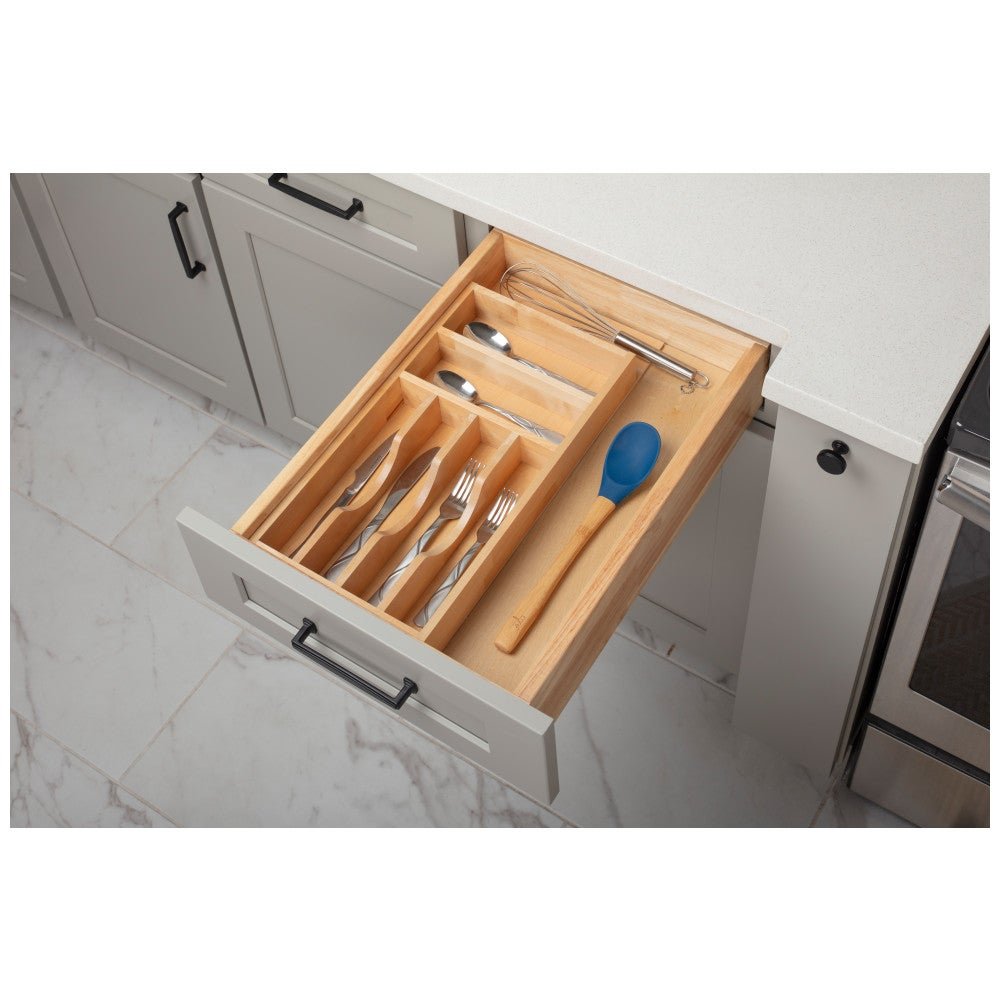 Cutlery drawer organizer holding forks, knives, spoons and a spatula
