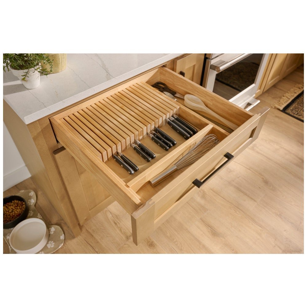 Knife block drawer organizer holding knives in an open kitchen drawer