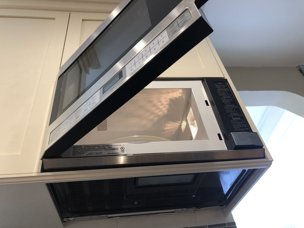 Detail of the over-the-counter microwave integrated into the cabinetry