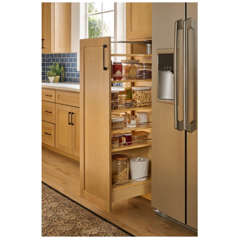 Birch pantry pullout organizer pulled out of a tall cabinet beside the refrigerator