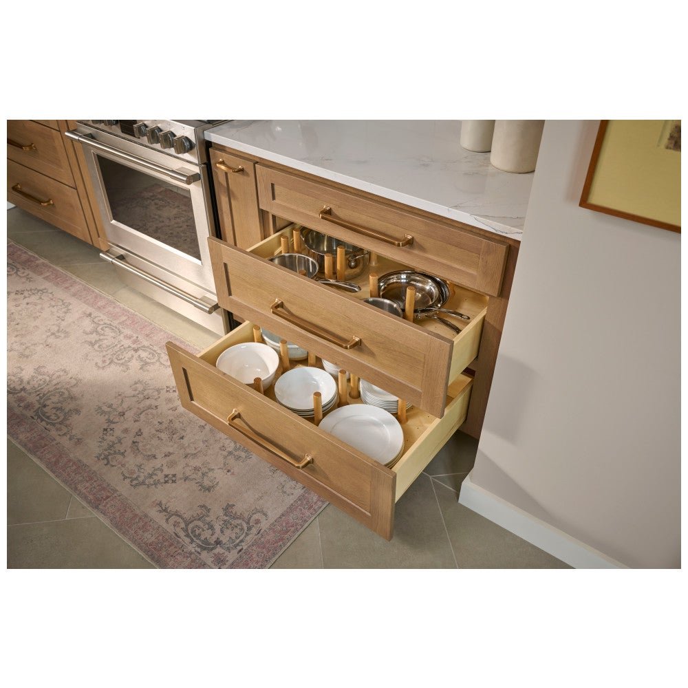 Deep kitchen drawers organized with peg board inserts for dishes
