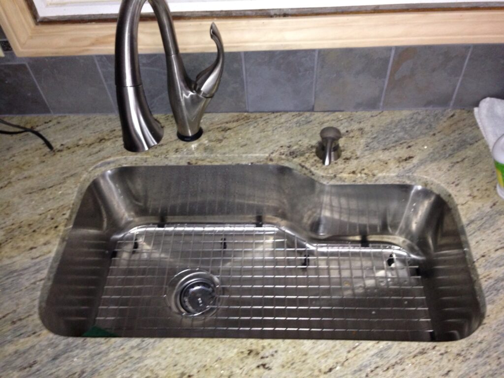 Kidney bowl stainless steel sink installed in a quartz countertop