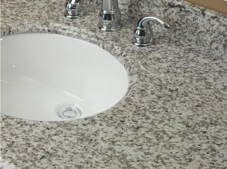 Oval ceramic vanity sink installed in a granite vanity top