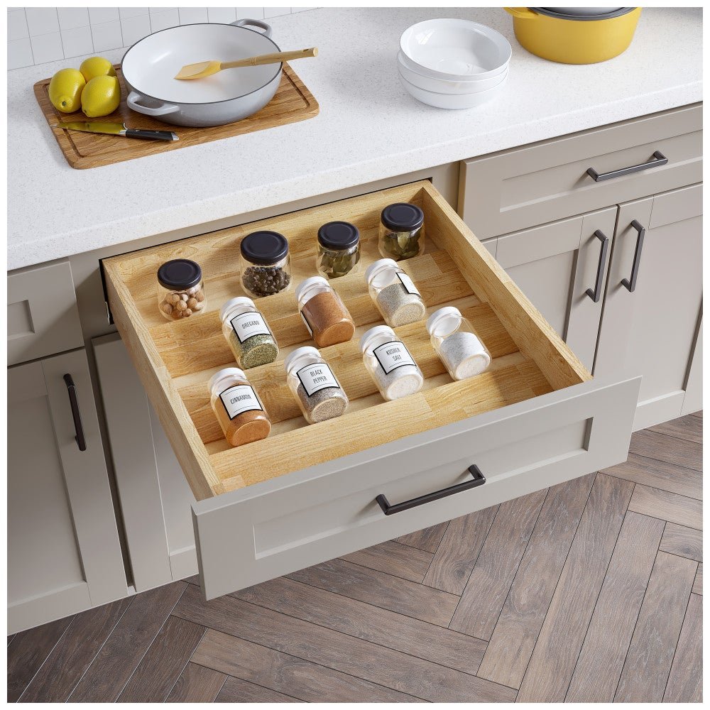 Wide spice drawer organizer holding rows of spice jars