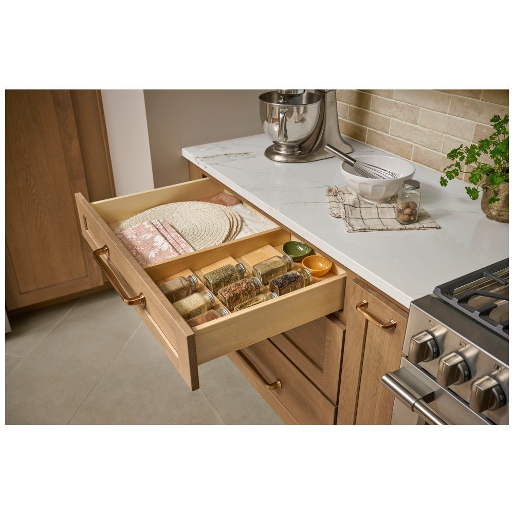 Spice drawer organizer in a drawer beside the range