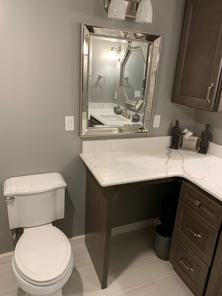 Quartz vanity with open knee space for seated access – finished basement bath, Randolph