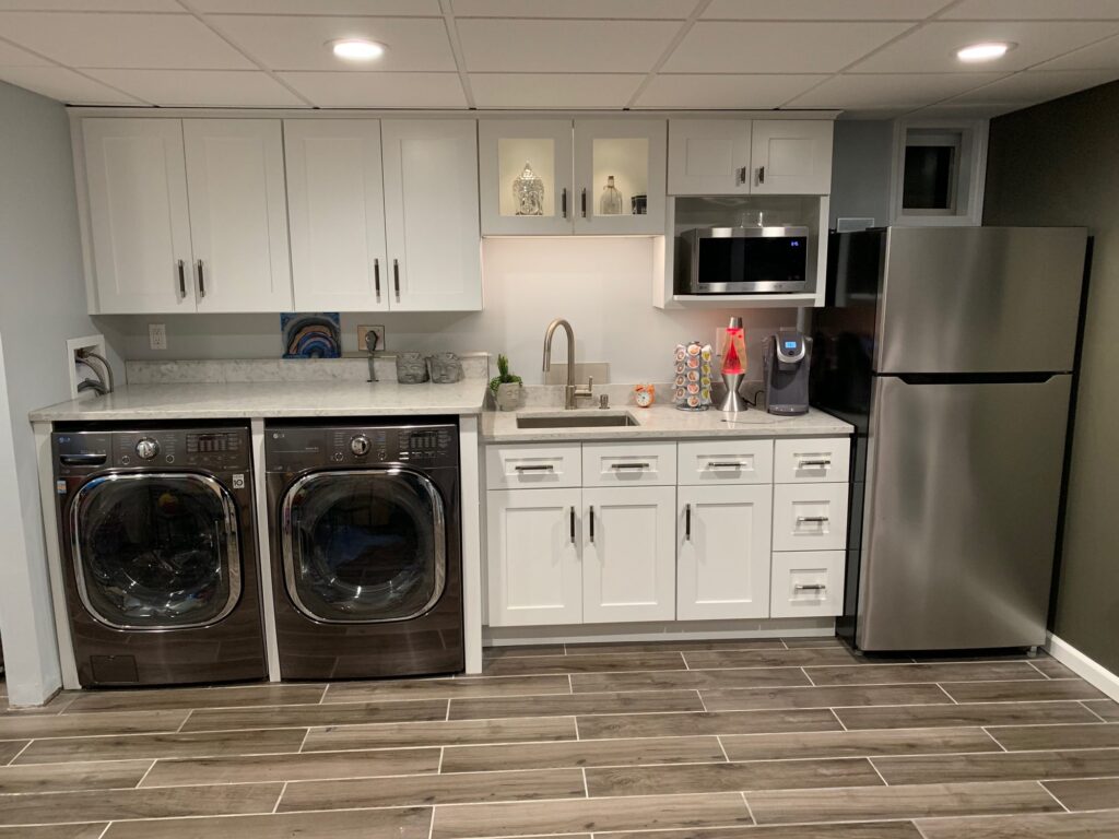Laundry kitchenette with white shaker cabinets and wood-look plank tile – Randolph