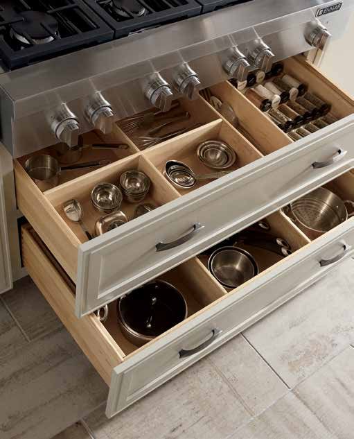 Angled view of Omega Blueprint custom drawers with divided compartments for spices, pans and tools