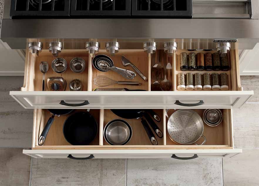 Two Omega Blueprint custom deep drawers under a range, with dividers for pans and holders for spices and gadgets