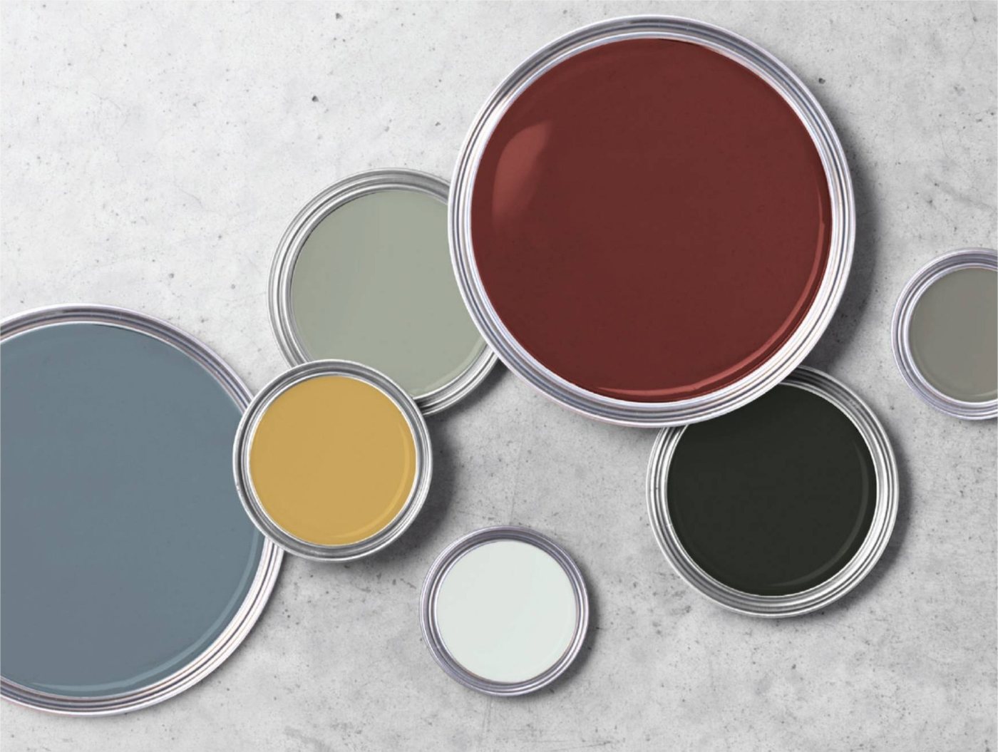 Open paint cans in a range of colors representing Omega custom opaque color matching